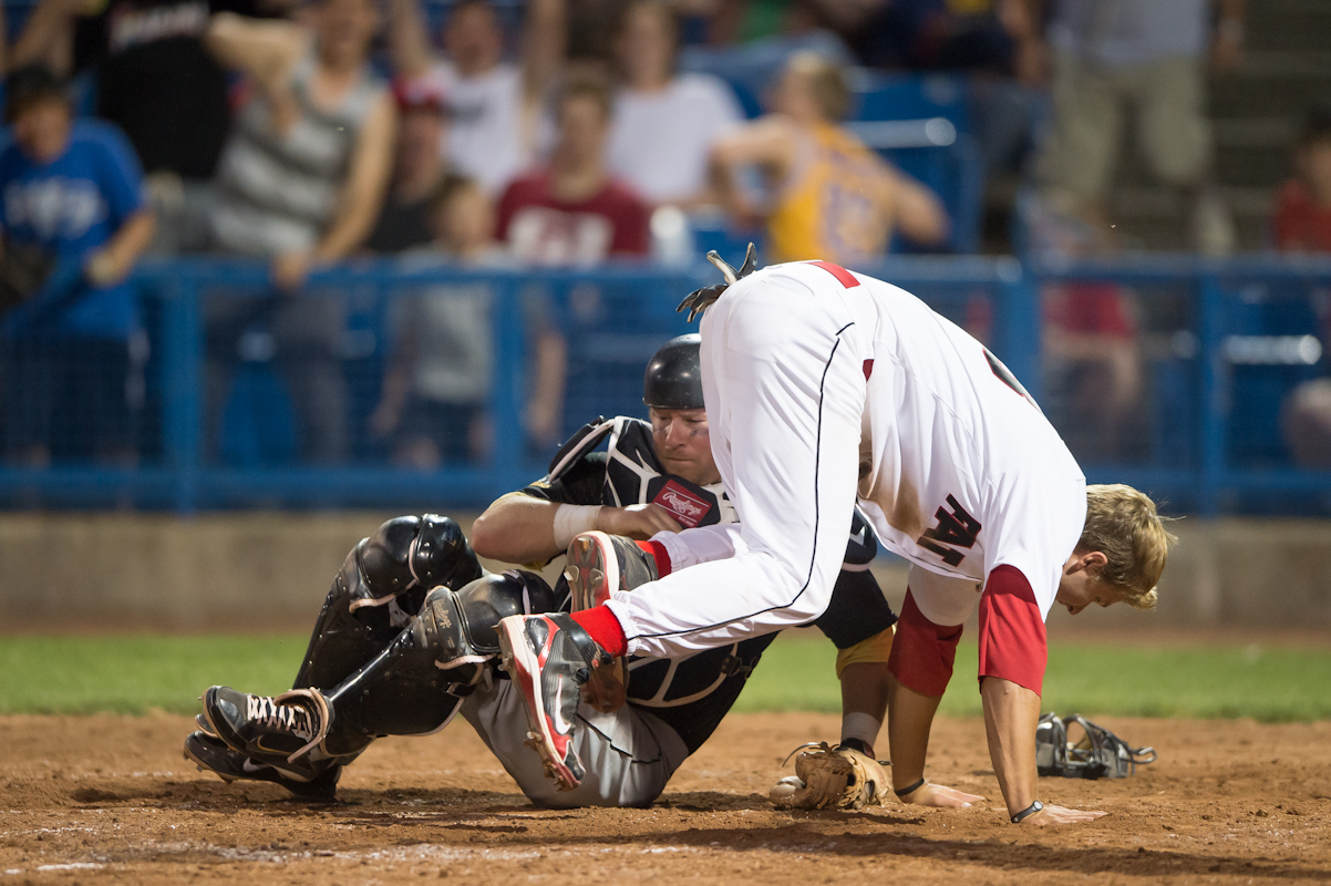 Fat Cats infielder Jason Coker (27) and Kitchener Panthers catcher Ben Kangas (27) collide in the seventh inning in the season opener at the Ottawa Stadium on Saturday May 19th, 2012. The Fat Cats defeated the Panther by a score of 7-0.