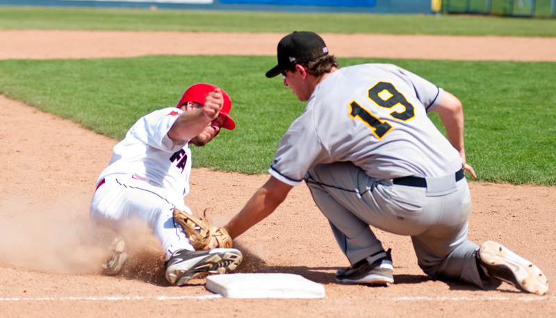 Ottawa Fat Cats Kevin Dietrich (14) slides into third base while Mat Taube (19) tries to make the tag in the game against the Ottawa Fat Cats at the Ottawa Stadium on Monday May 21th, 2012. The Panthers defeated the Fat Cat's by a score of 12-11.