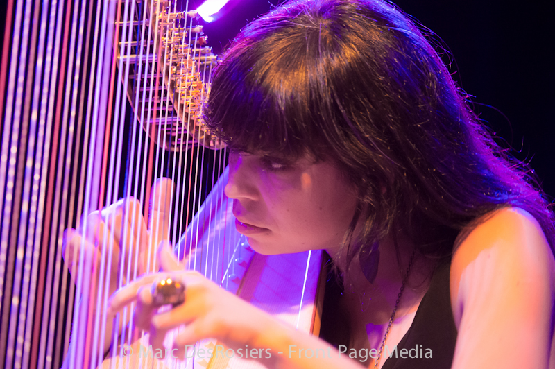 Sarah Page plays the harp as part of the Barr Brothers performance on the OLG stage at Ottawa Jazzfest at Confederation Park on June 21st, 2012