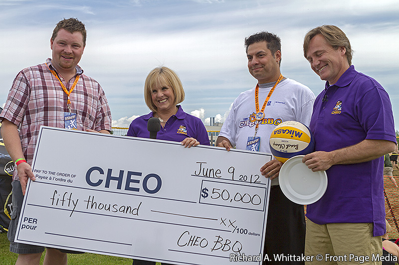 Mike Machargo and Johnny Hunt present a cheque to CHEO in the amount of $50,000 from the 2011 CHEO BBQ